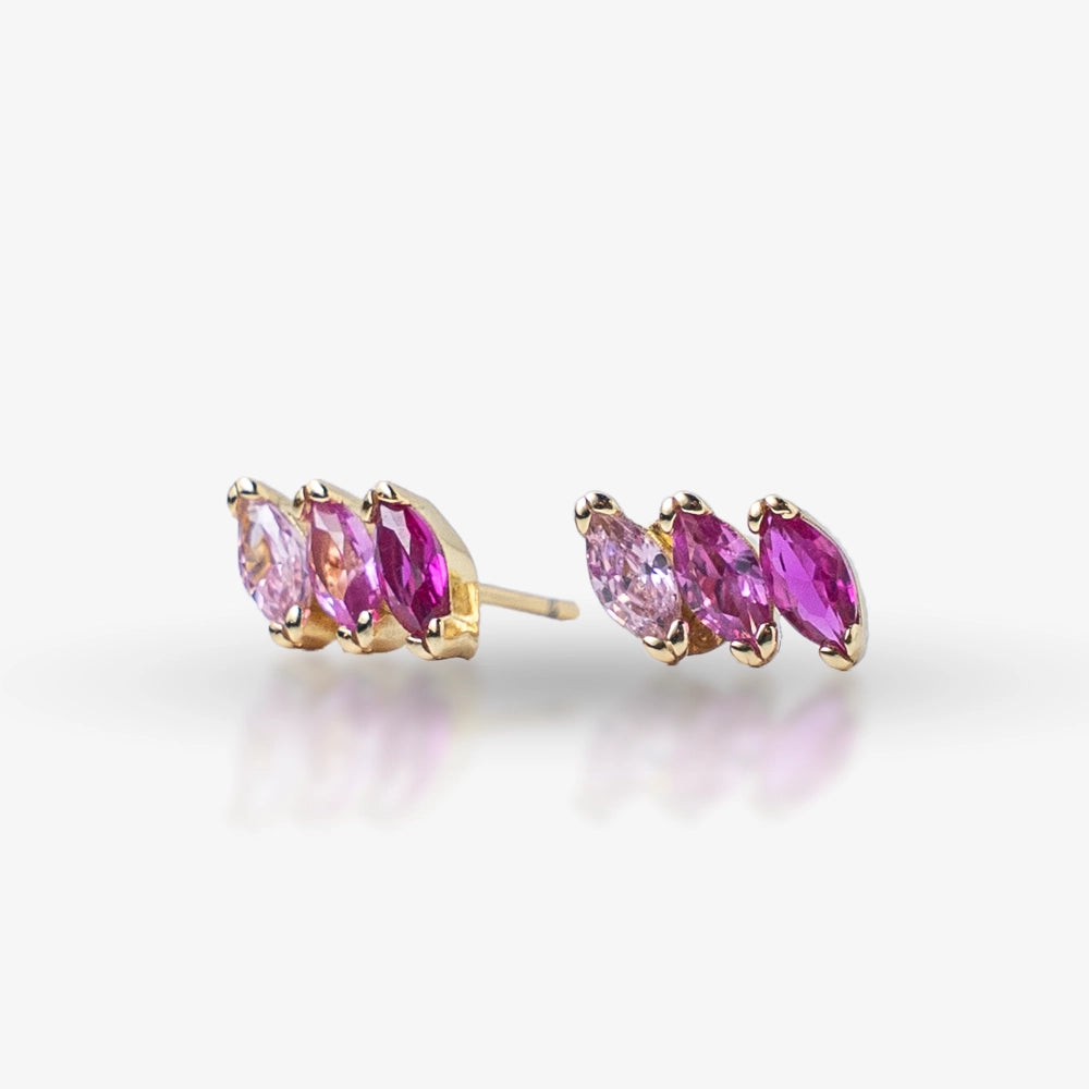 Elegant and stylish, these gold-plated stud earrings feature a row of pink marquise-cut stones, adding a delicate and sophisticated touch to any look.