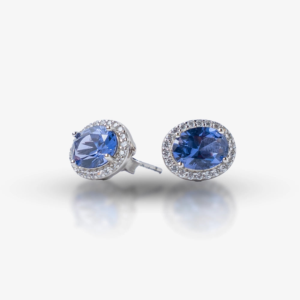 Add a touch of timeless luxury to your jewelry collection with these stunning Sapphire Elegance Silver Stud Earrings. Crafted in 925 sterling silver, they feature radiant blue sapphire-hued gemstones surrounded by a delicate halo of shimmering stones. Perfect for elevating any look, these earrings blend classic sophistication with modern charm.