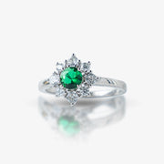 Elegant and timeless, this Sterling Silver 925 Emerald & Diamond Halo Ring features a stunning green stone at its center, surrounded by a sparkling halo of white stones. Its vintage-inspired design adds a royal touch to any look.