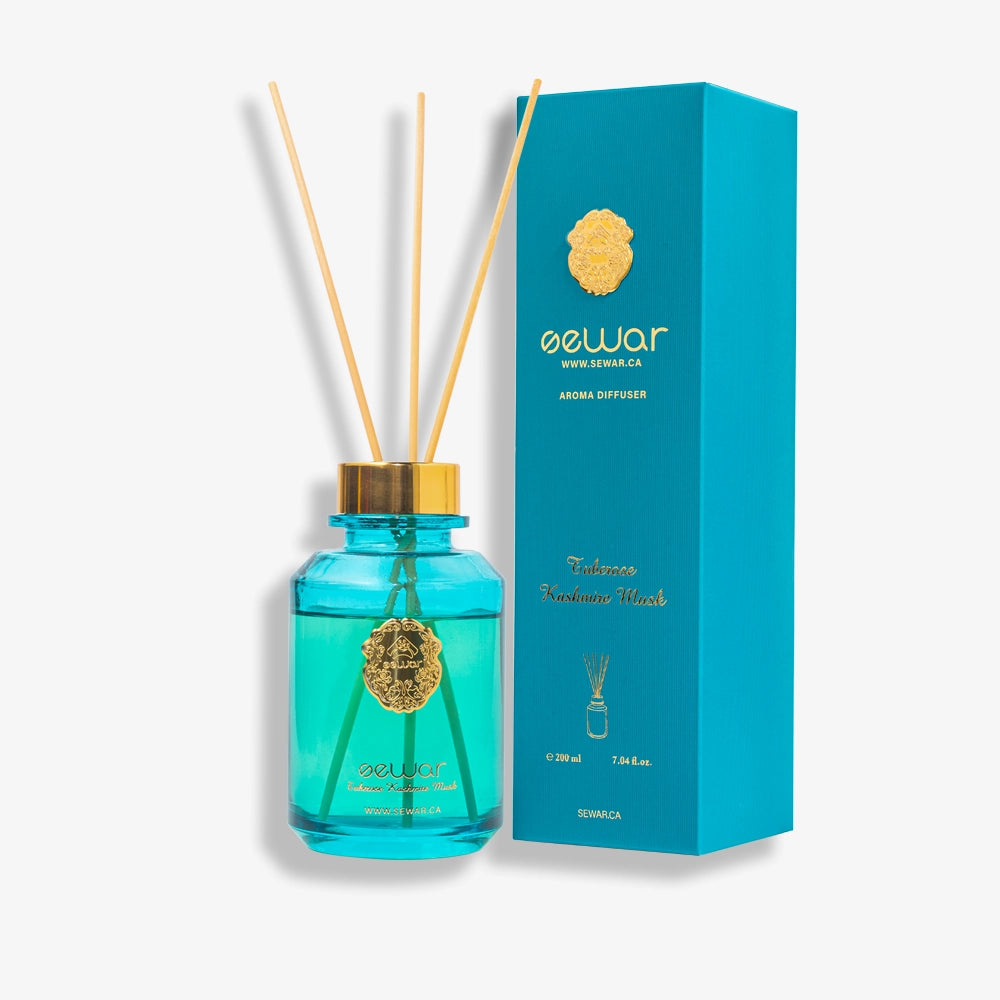 A sleek, premium glass bottle with a metallic logo, filled with Sewar Tuberose & Kashmir Musk Reed Diffuser. The diffuser is adorned with elegant reeds, showcasing the fresh and floral fragrance. The design adds a touch of sophistication and luxury, perfect for enhancing the atmosphere of any spa