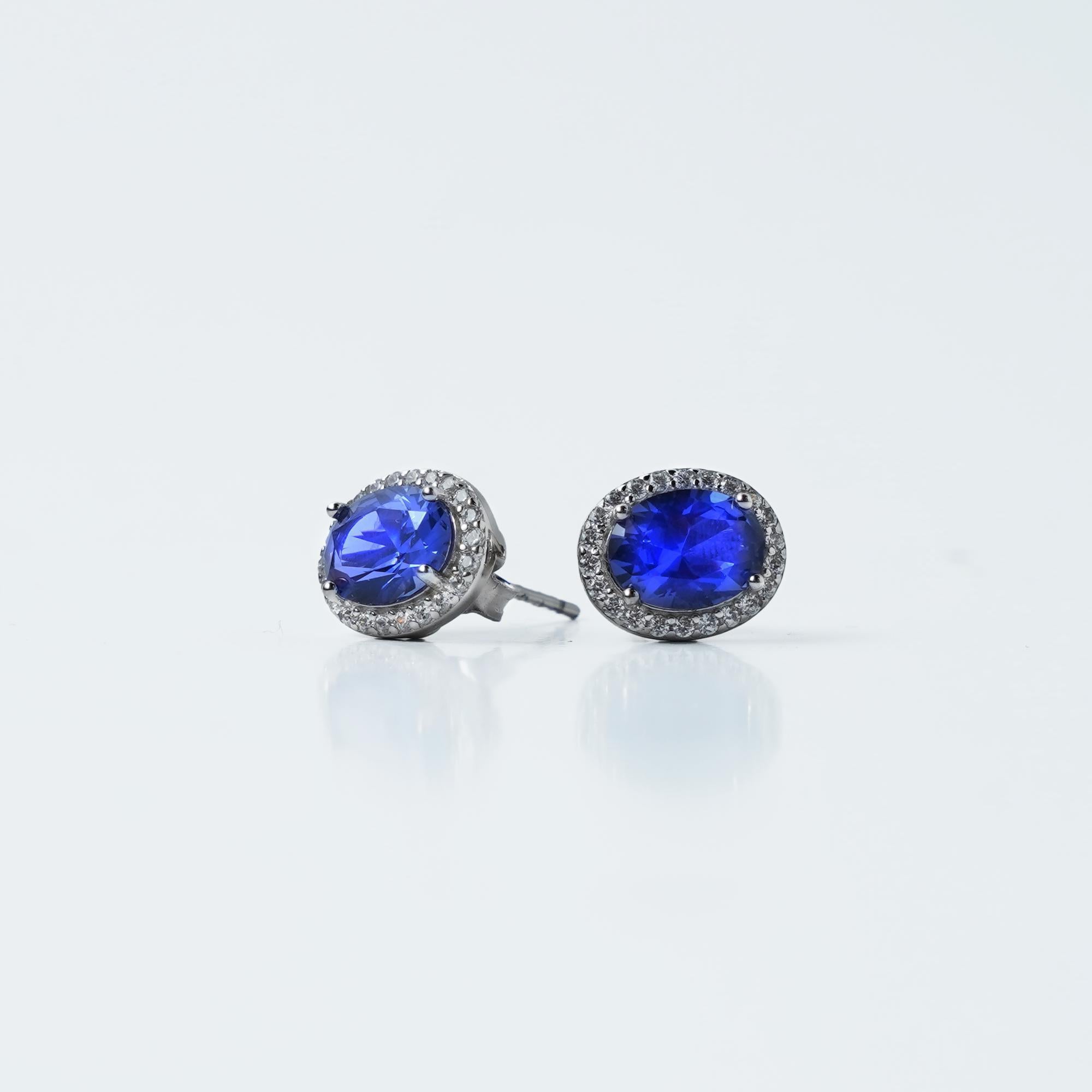 Add a touch of timeless luxury to your jewelry collection with these stunning Sapphire Elegance Silver Stud Earrings. Crafted in 925 sterling silver, they feature radiant blue sapphire-hued gemstones surrounded by a delicate halo of shimmering stones. Perfect for elevating any look, these earrings blend classic sophistication with modern charm.