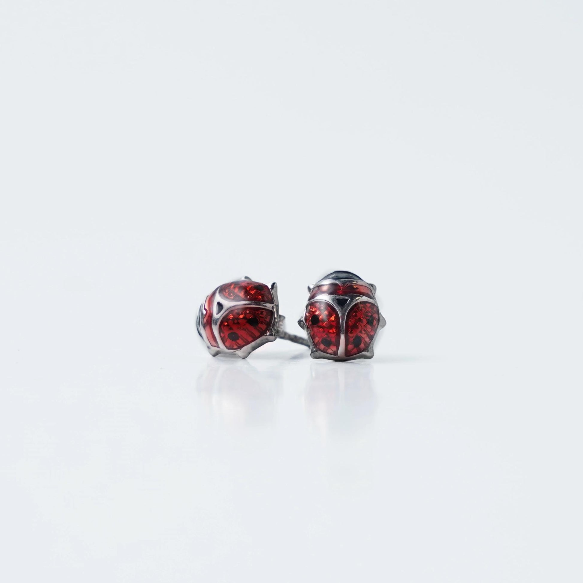 Add a playful touch to your style with these Sterling Silver 925 Red Ladybug Stud Earrings. Featuring a charming ladybug design with vibrant red stones, these earrings bring a unique and fun flair to any outfit