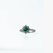 Elegant and timeless, this Sterling Silver 925 Emerald &amp; Diamond Halo Ring features a stunning green stone at its center, surrounded by a sparkling halo of white stones. Its vintage-inspired design adds a royal touch to any look.