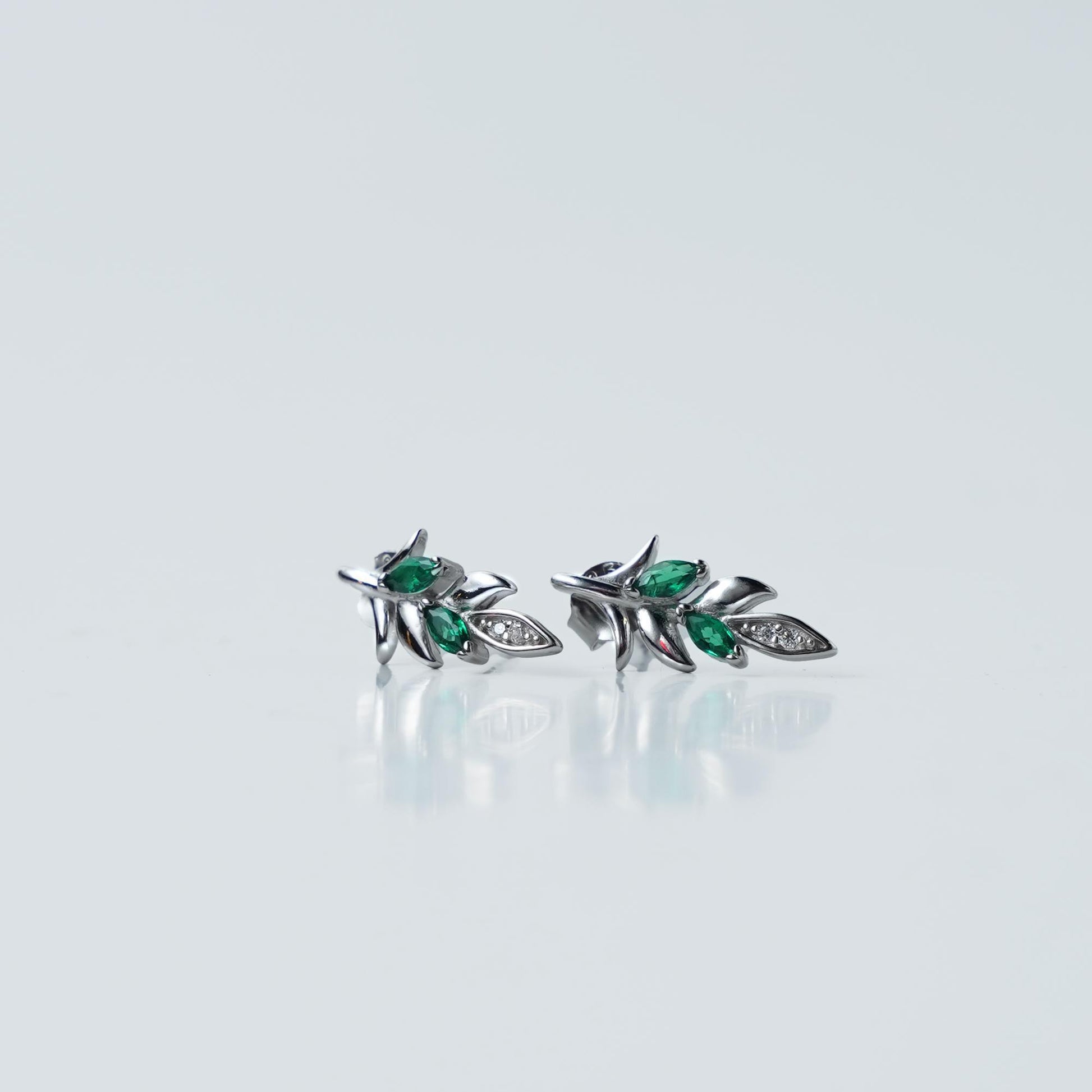 Elegant and stylish, these Sterling Silver 925 Green Leaf Stud Earrings feature a delicate leaf design with green and white stones for a touch of sparkle.